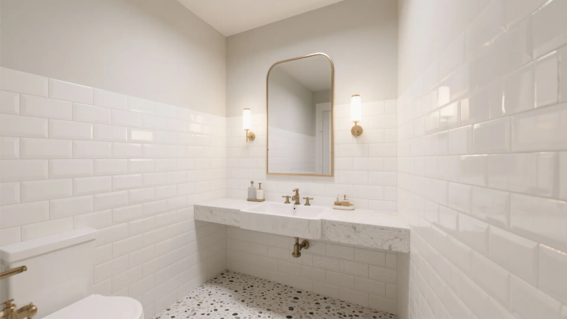 White bathroom with subway tiles marble sink gold mirror wall lights and a speckled floor