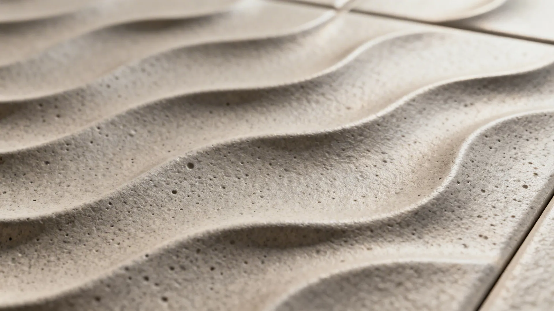 Macro view of matte 3D wave tile with soft grazing light showing texture.