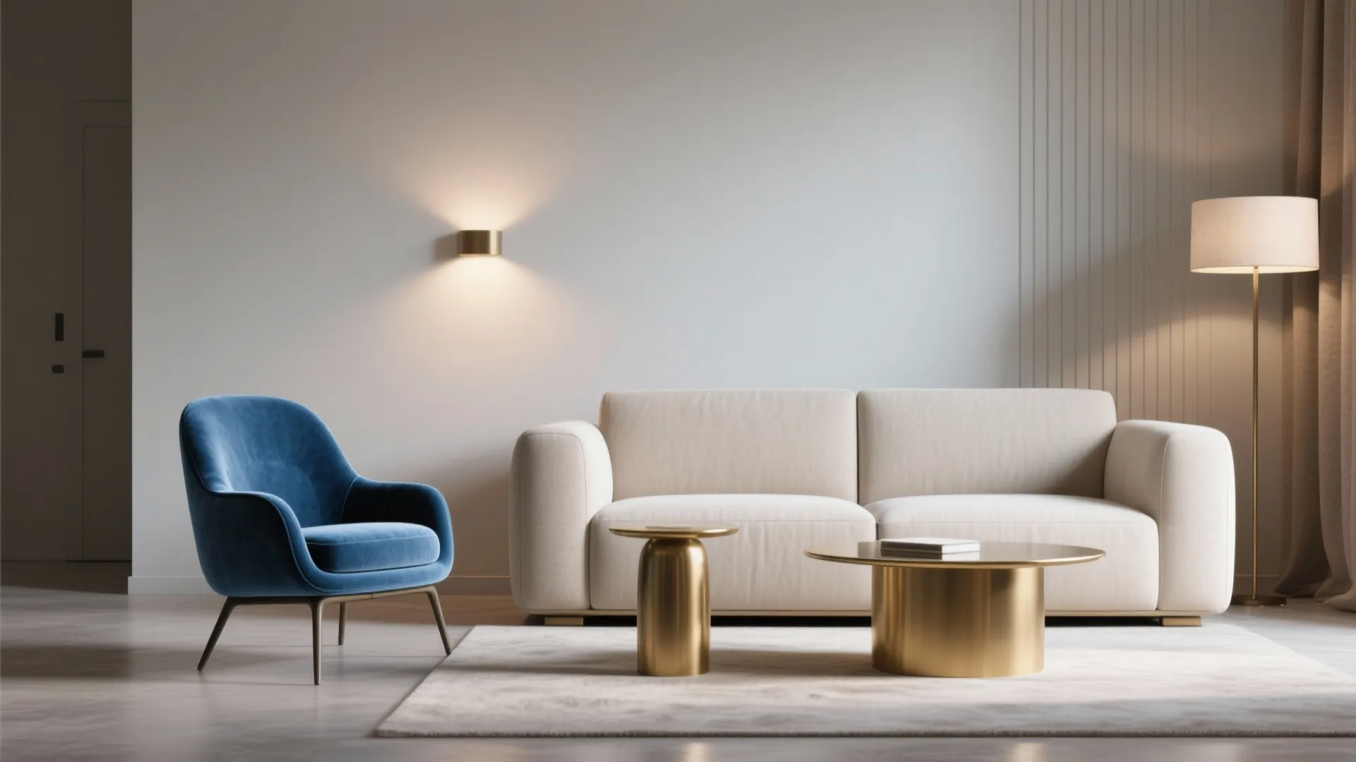 Neutral minimalist sofa with a standout blue velvet accent chair and brass side table.
