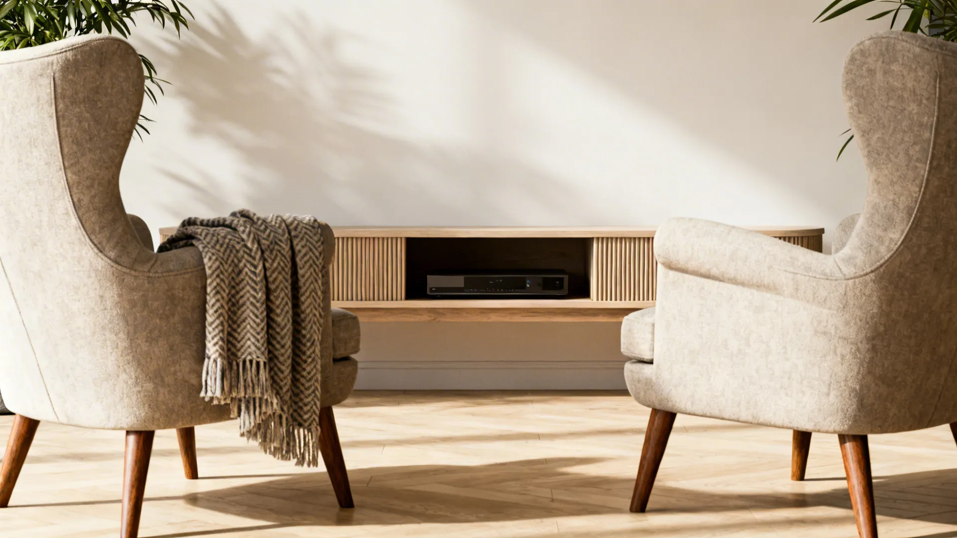 Two accent chairs paired with a slender media console in a welcoming small living room.