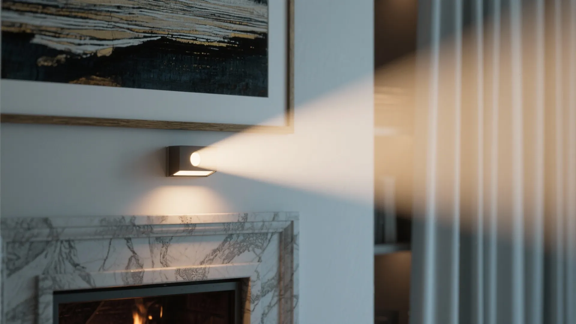 Wall light fixture above marble fireplace shining a beam of light on a framed painting