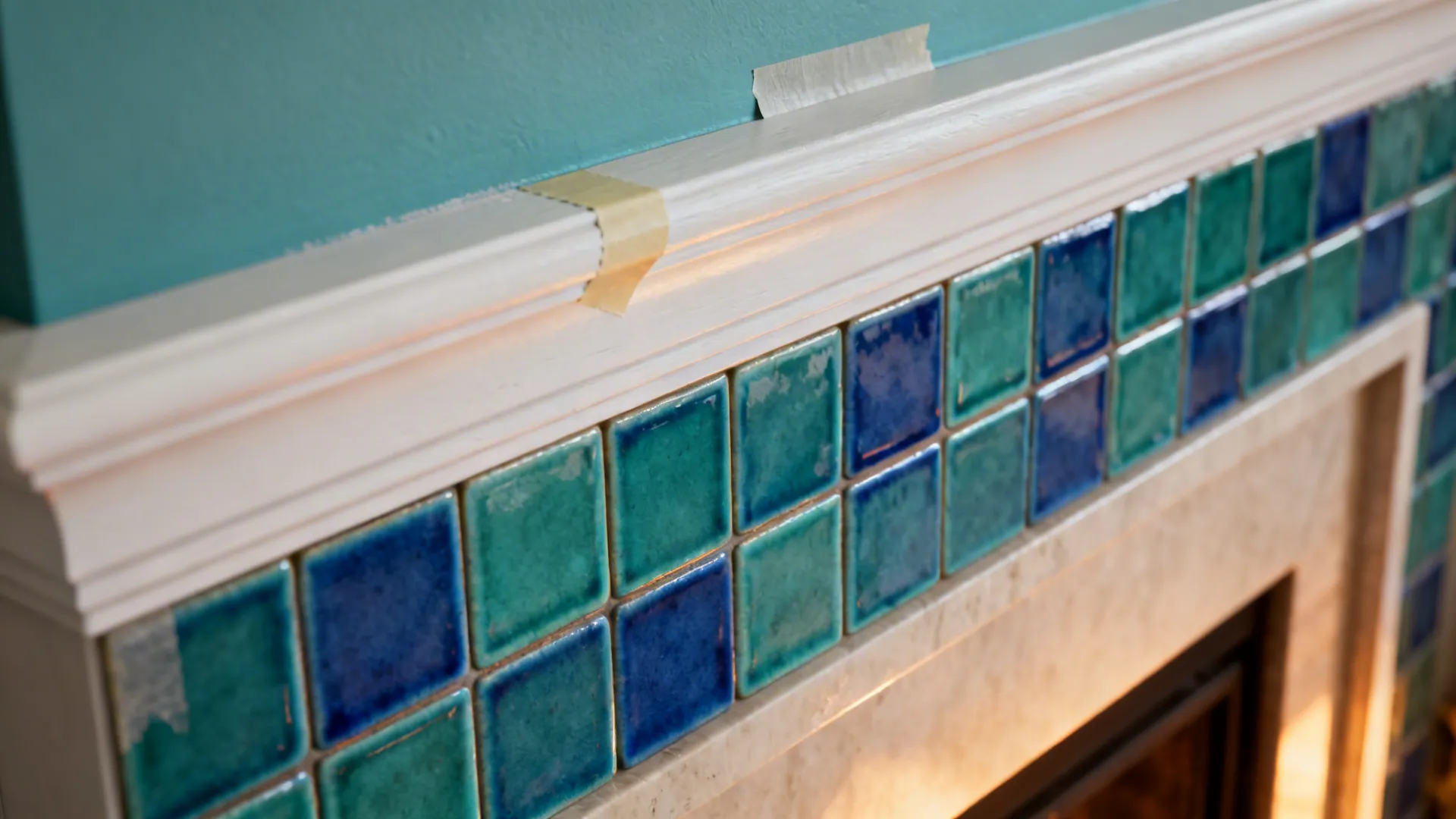 Close-up of blue-green ceramic tiles and a soft-teal painted ceiling edge