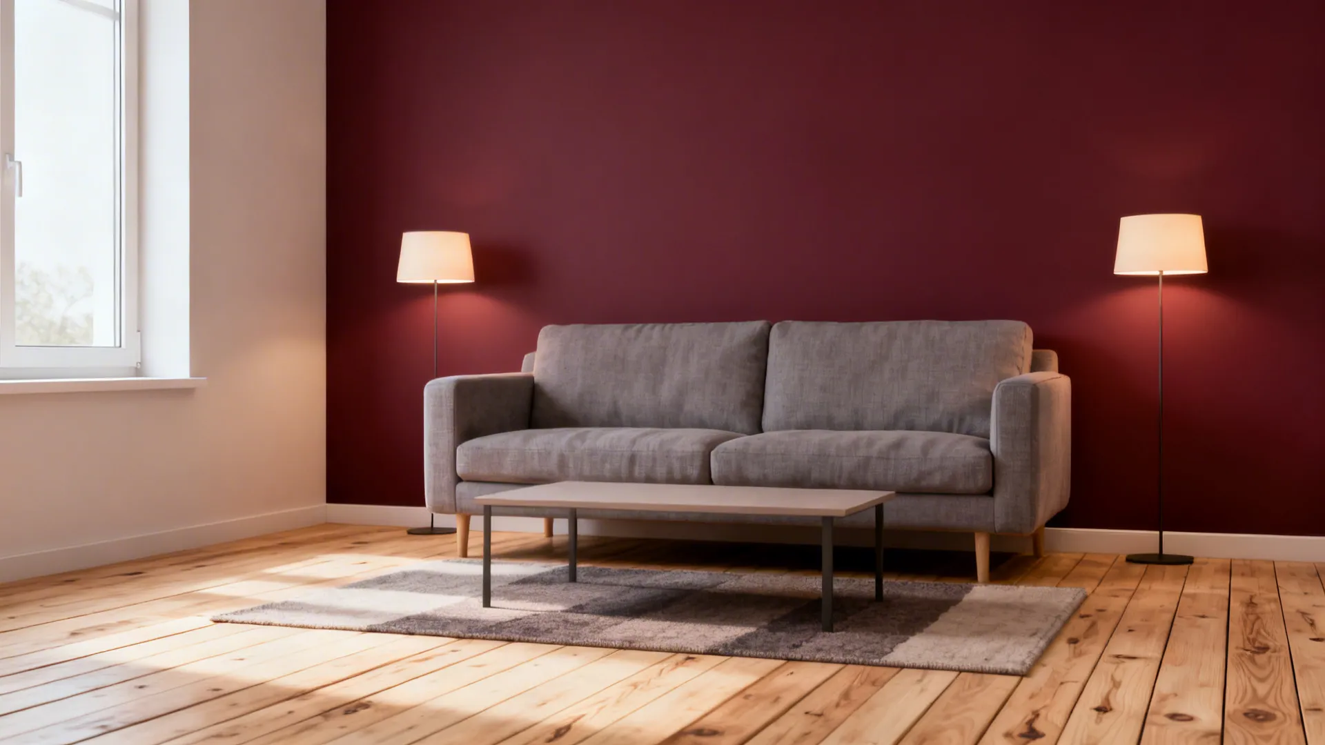 Small living area with a deep burgundy accent wall and dove-gray seating on light wood floors.