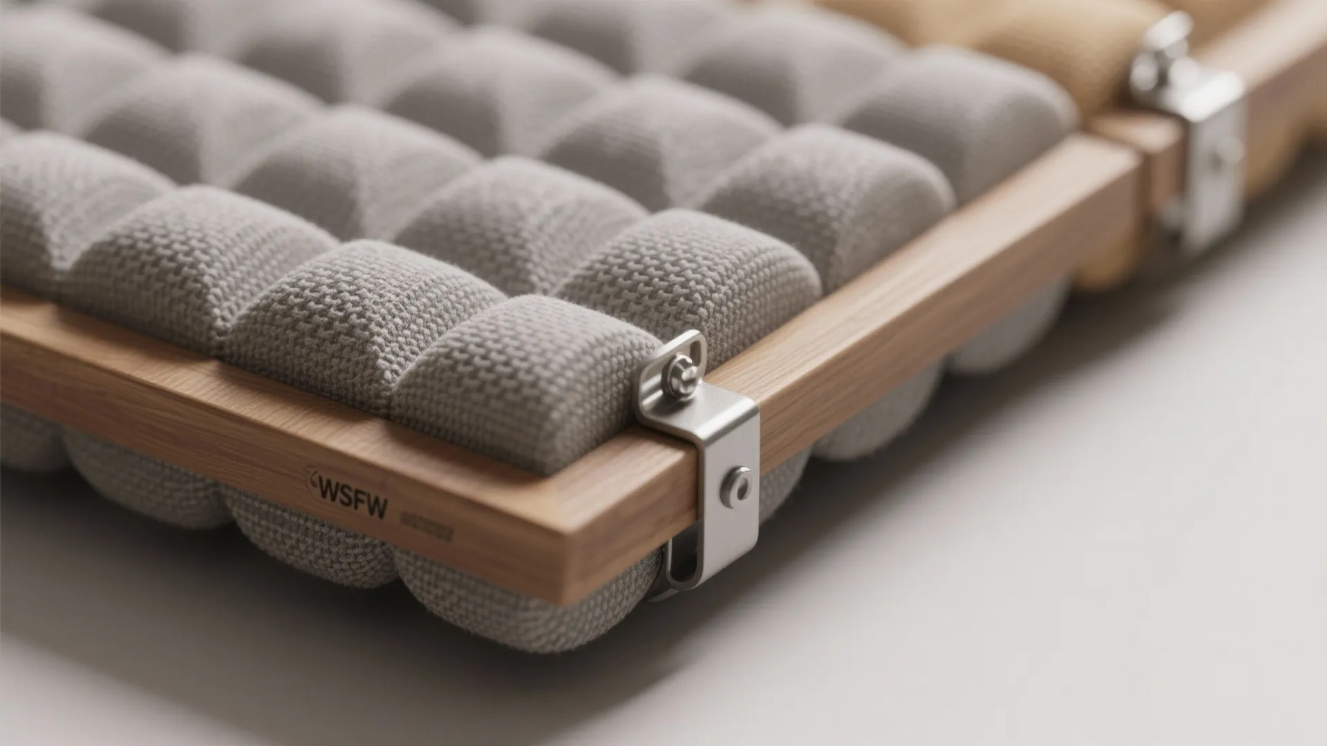 Grey fabric panels fixed with metal clips on a wooden frame for a modern wall panel