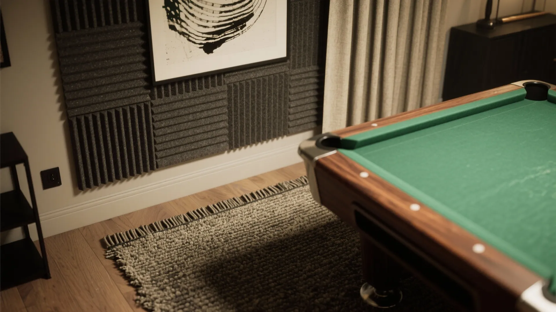 Close up of a pool table next to grey wall panels and a textured floor rug