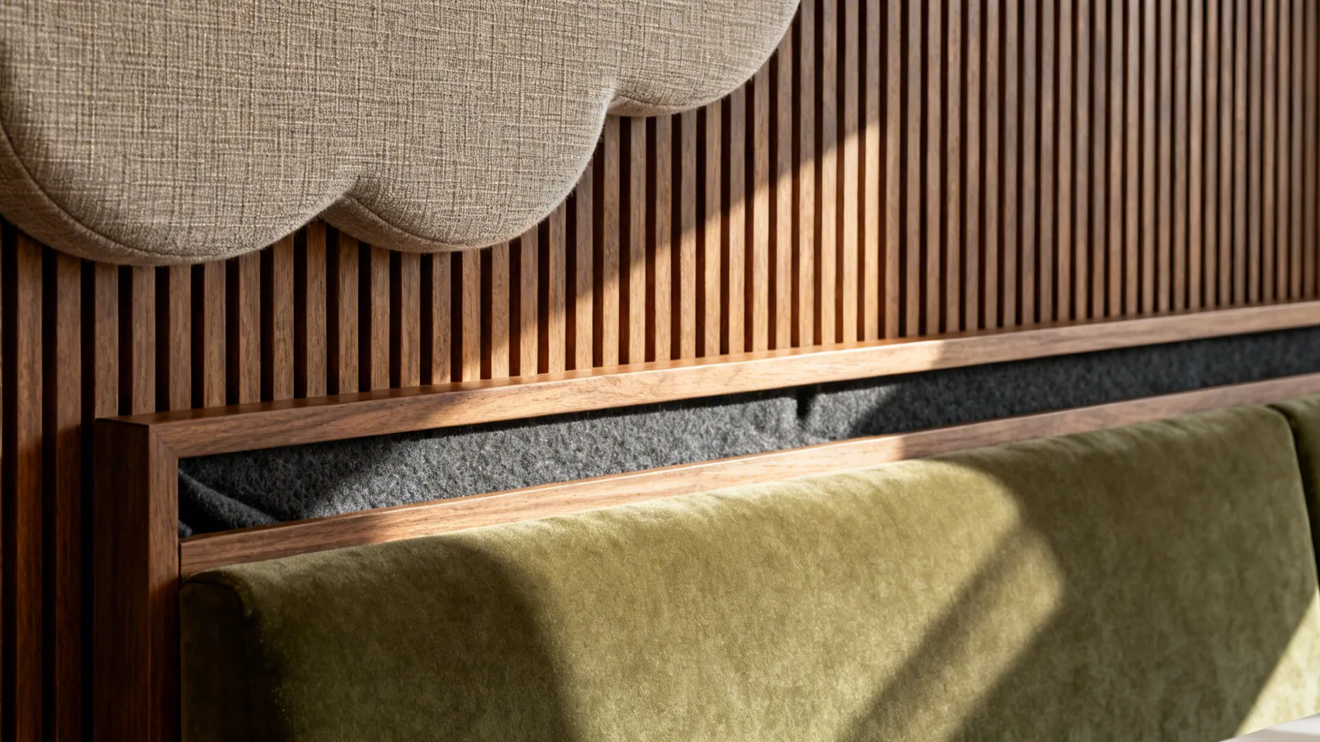 Macro of fabric acoustic cloud, ribbed wood diffuser, and felt-lined millwork in a private dining room.