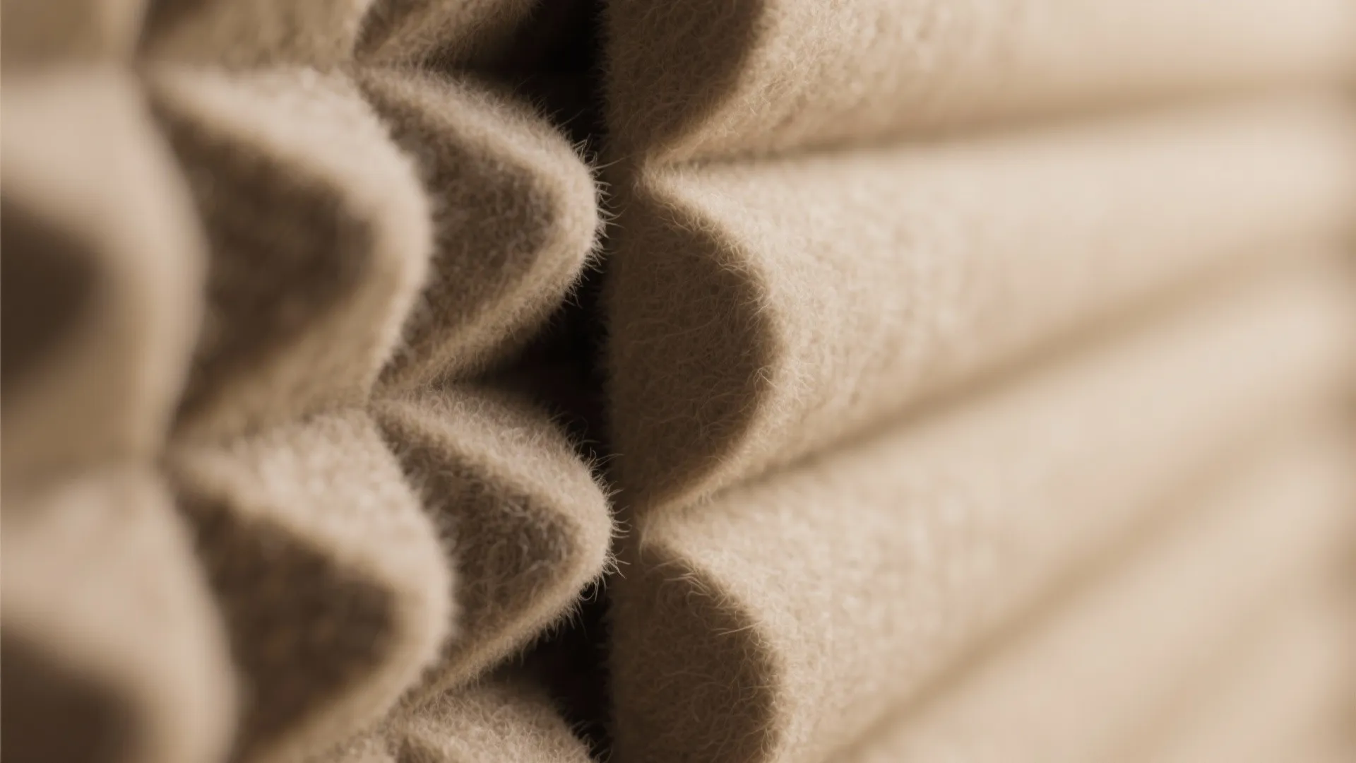 Close up of soft beige fabric material with a textured pattern for wall sound insulation