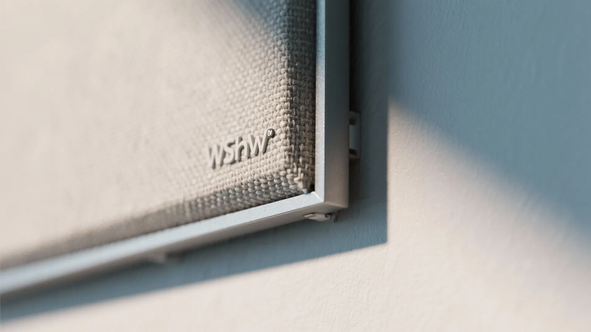 Macro of a fabric-wrapped acoustic panel showing detailed textile texture and crisp edges.