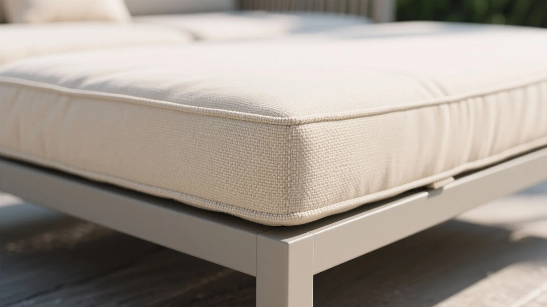 Macro detail of solution-dyed acrylic cushion with piped edge on modular balcony seat.