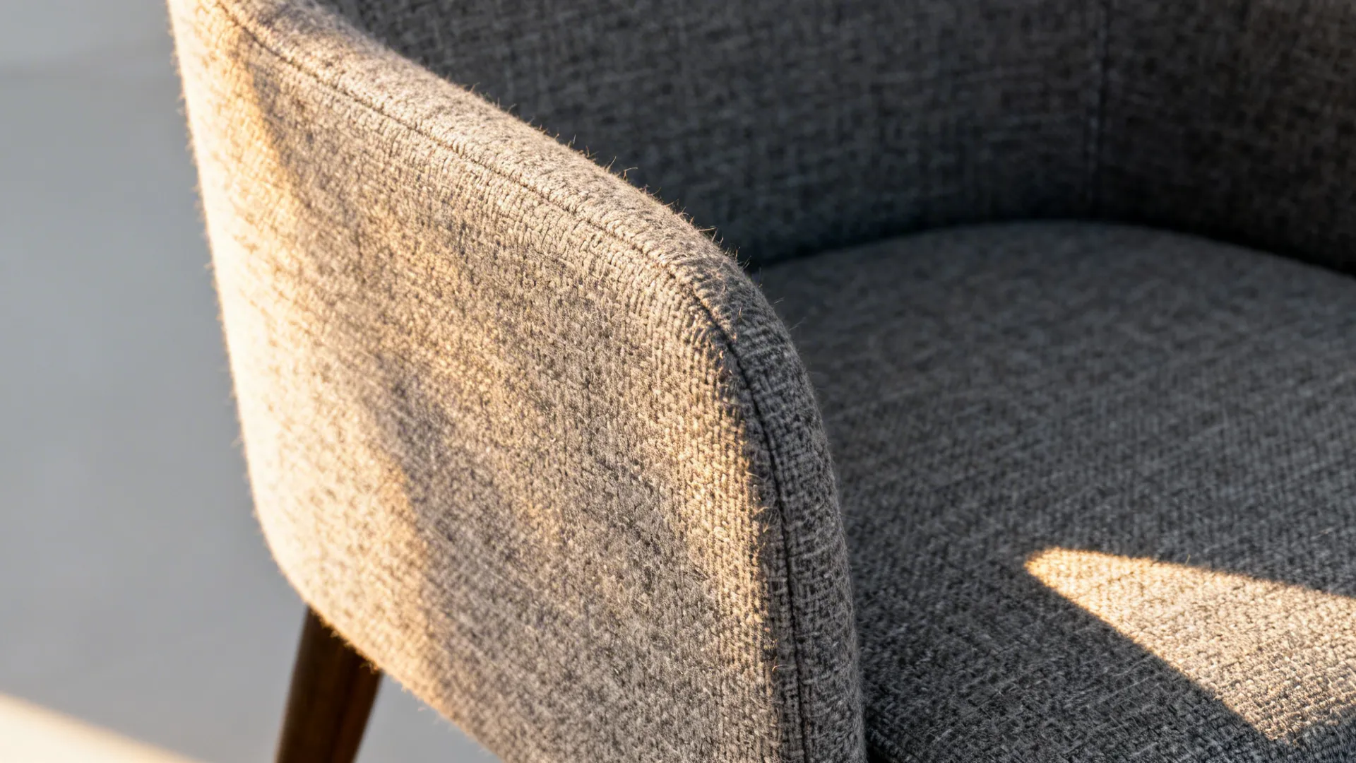 Macro of gray heather solution-dyed acrylic weave with sunlit texture.