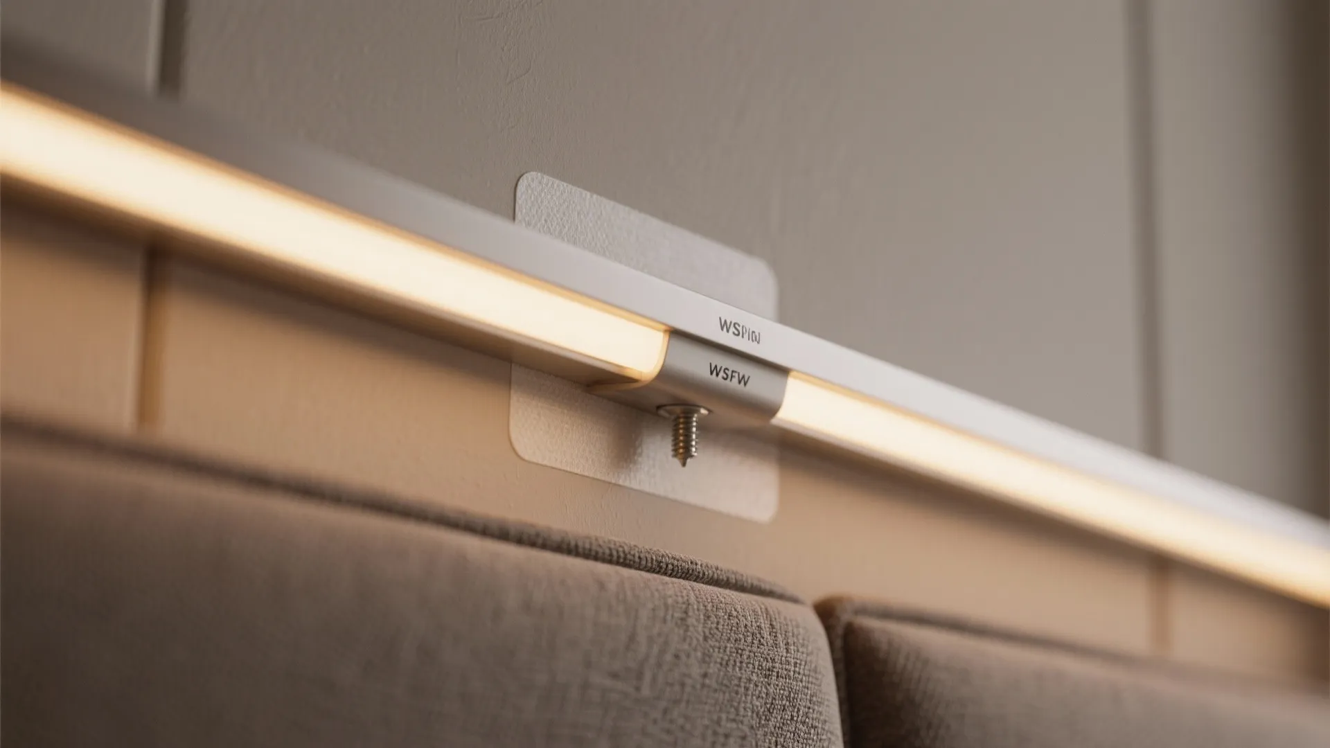 Close up showing a warm light bar fixed to a wall using a white adhesive