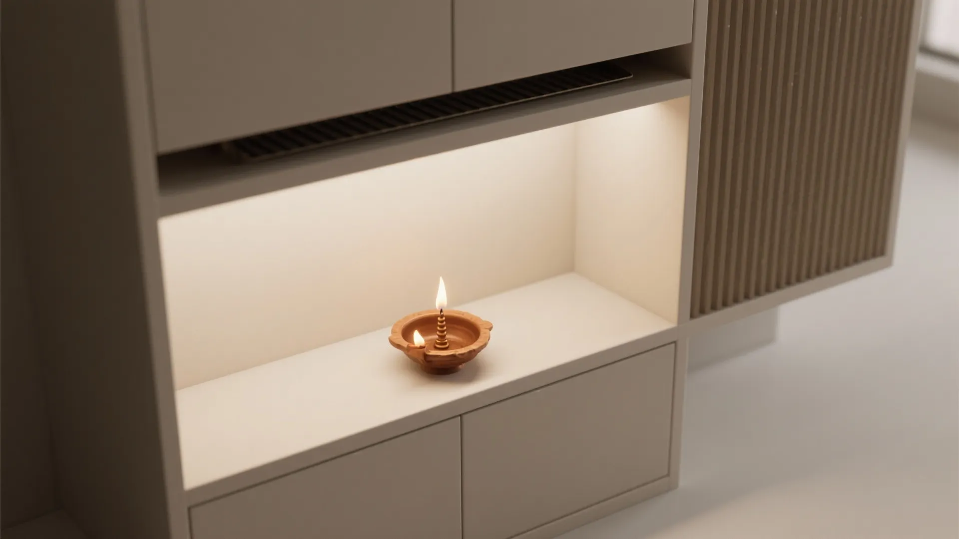 Small clay oil lamp burning inside a white cabinet shelf with warm light fixture built in