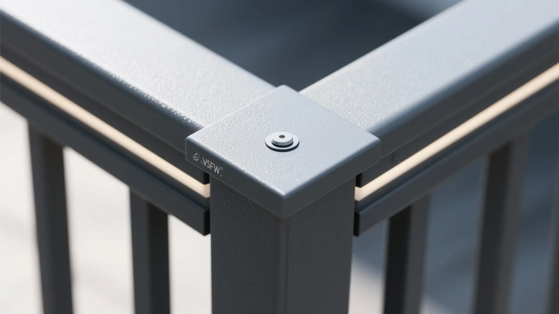 Close up of dark grey metal railing corner joint with small round bolt and lights
