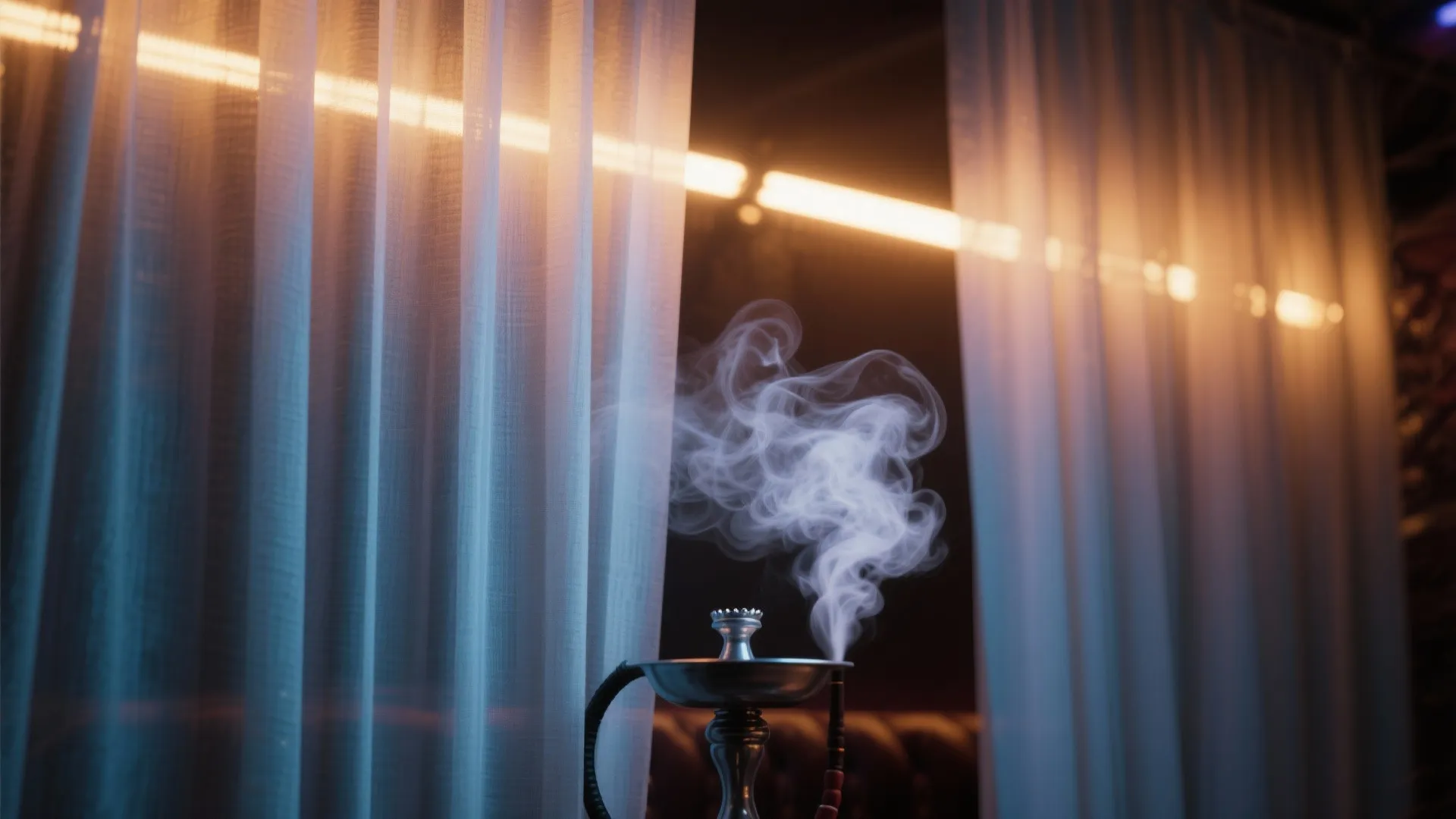 Smoke rising from a silver water pipe in front of white curtain and warm lights