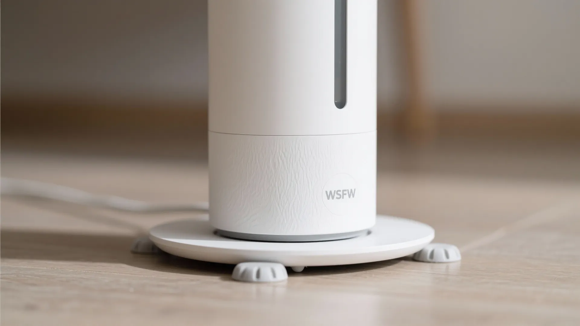 Macro detail of humidifier base with anti-tip pads on a firm floor.