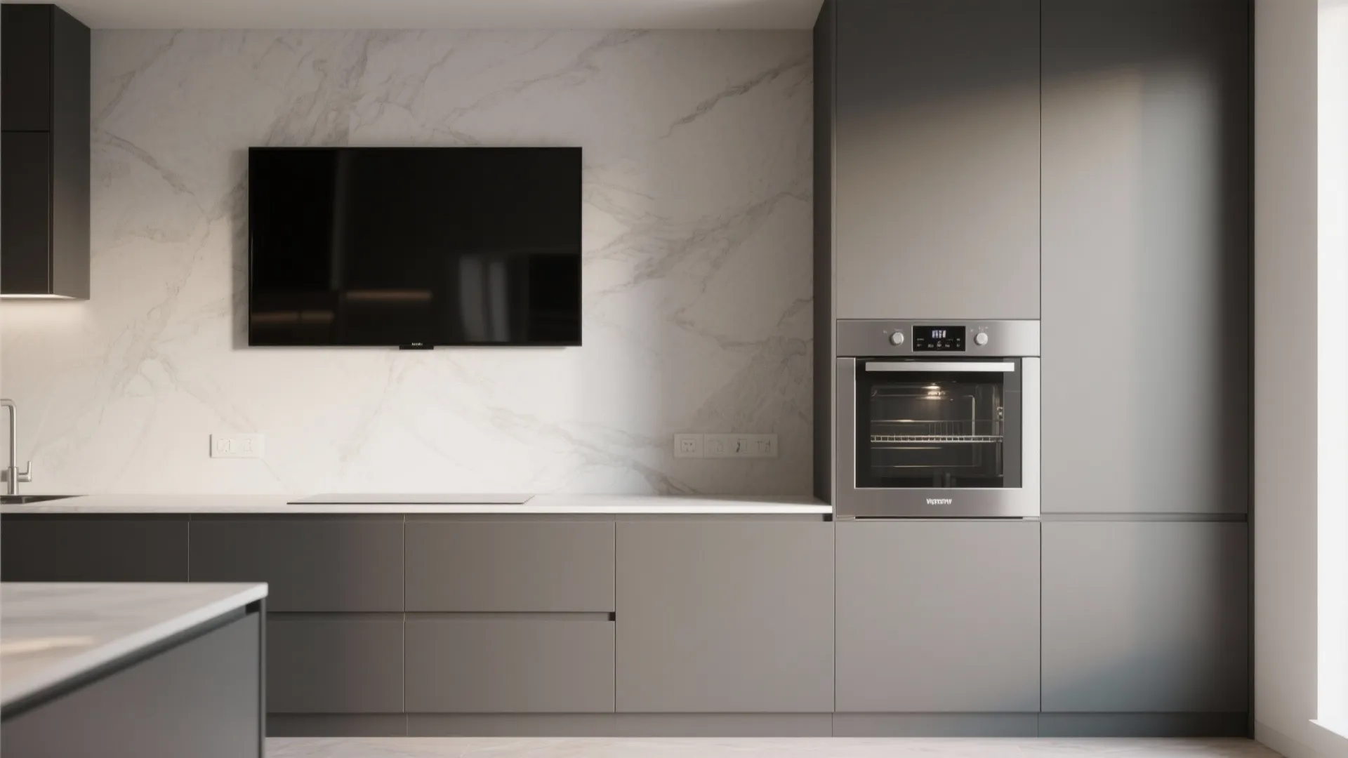 Grey kitchen cabinet system with built in oven and television screen on marble wall background