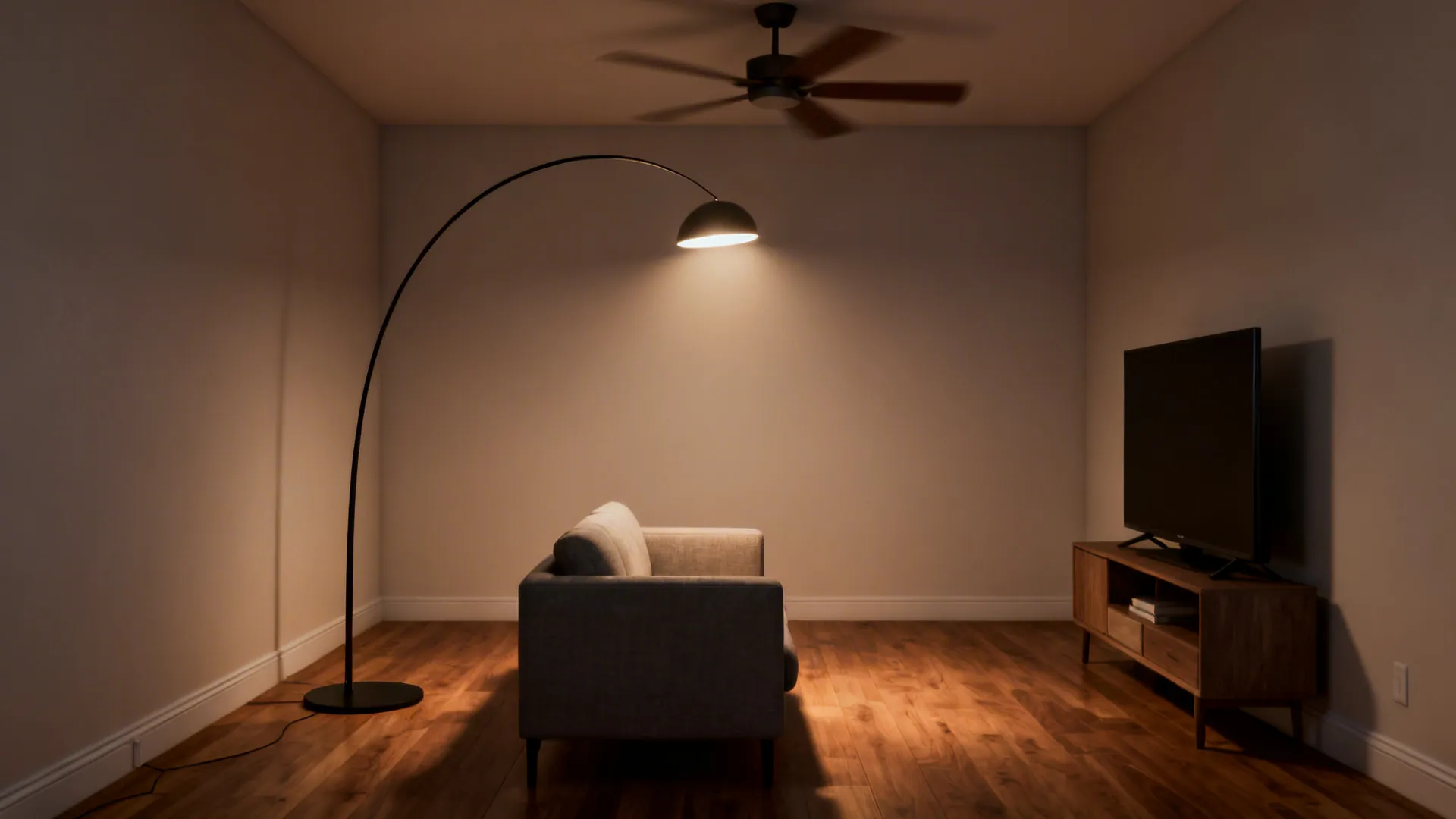 Slim arc floor lamp arcing over a small sofa with visible clearance from ceiling fan and TV