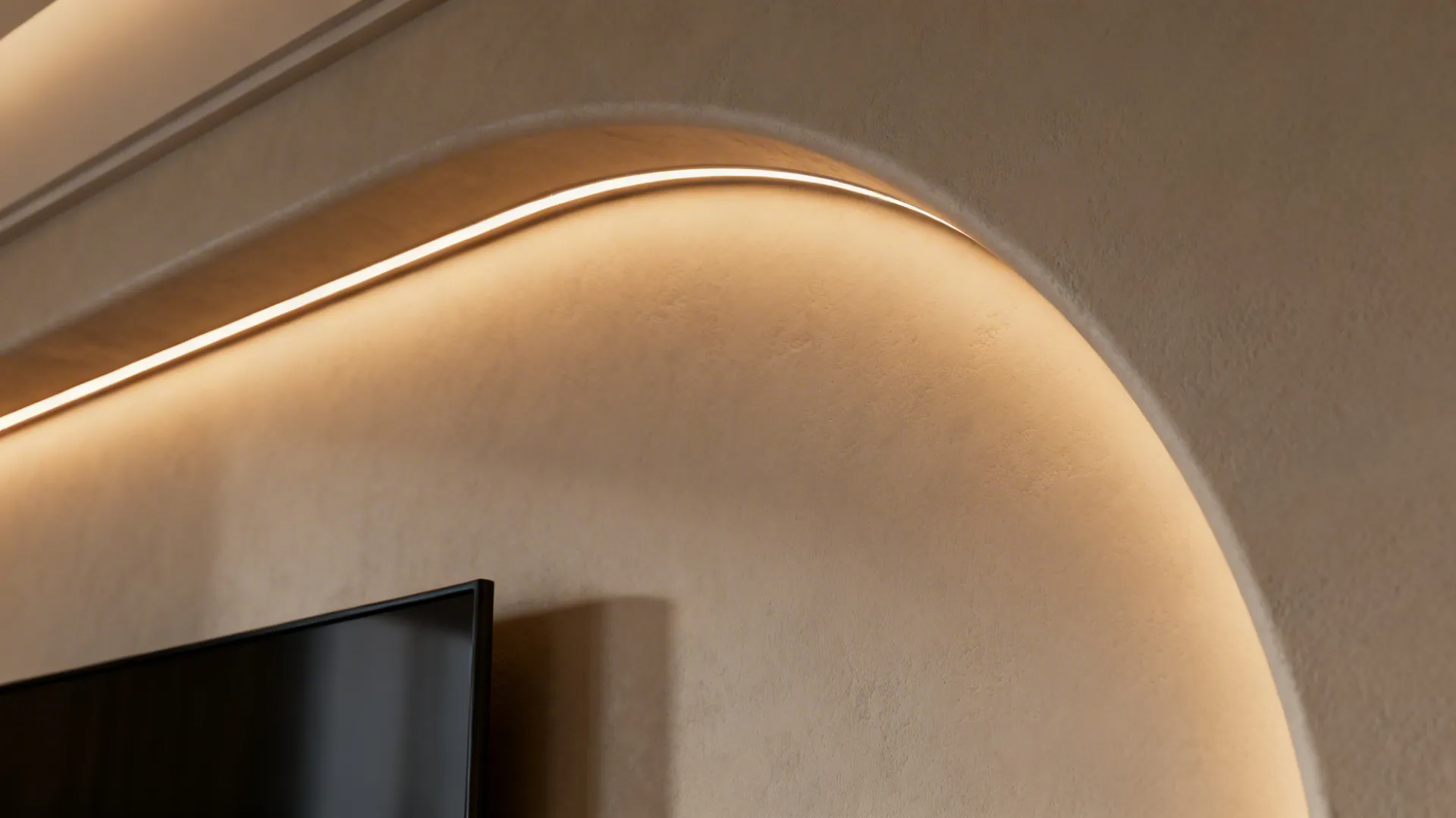 Curved wall with hidden light strip glowing above a flat screen television in a room