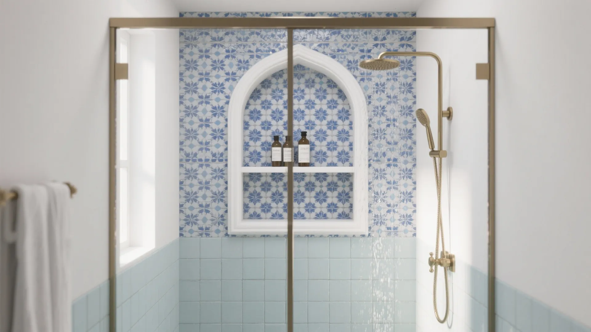 Modern shower with blue patterned tiles white arched wall niche gold shower head and glass