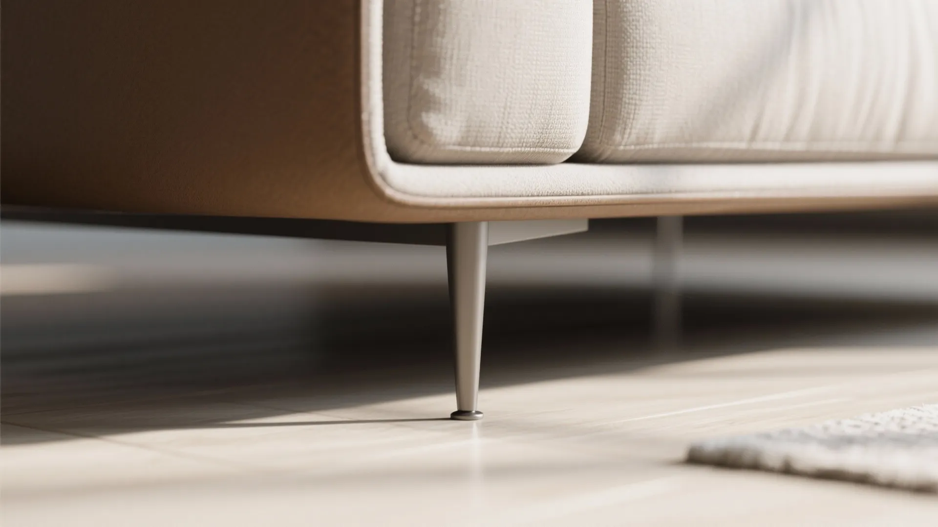 Detail of a cantilevered sofa with tapered legs showing visible floor for an airy look.