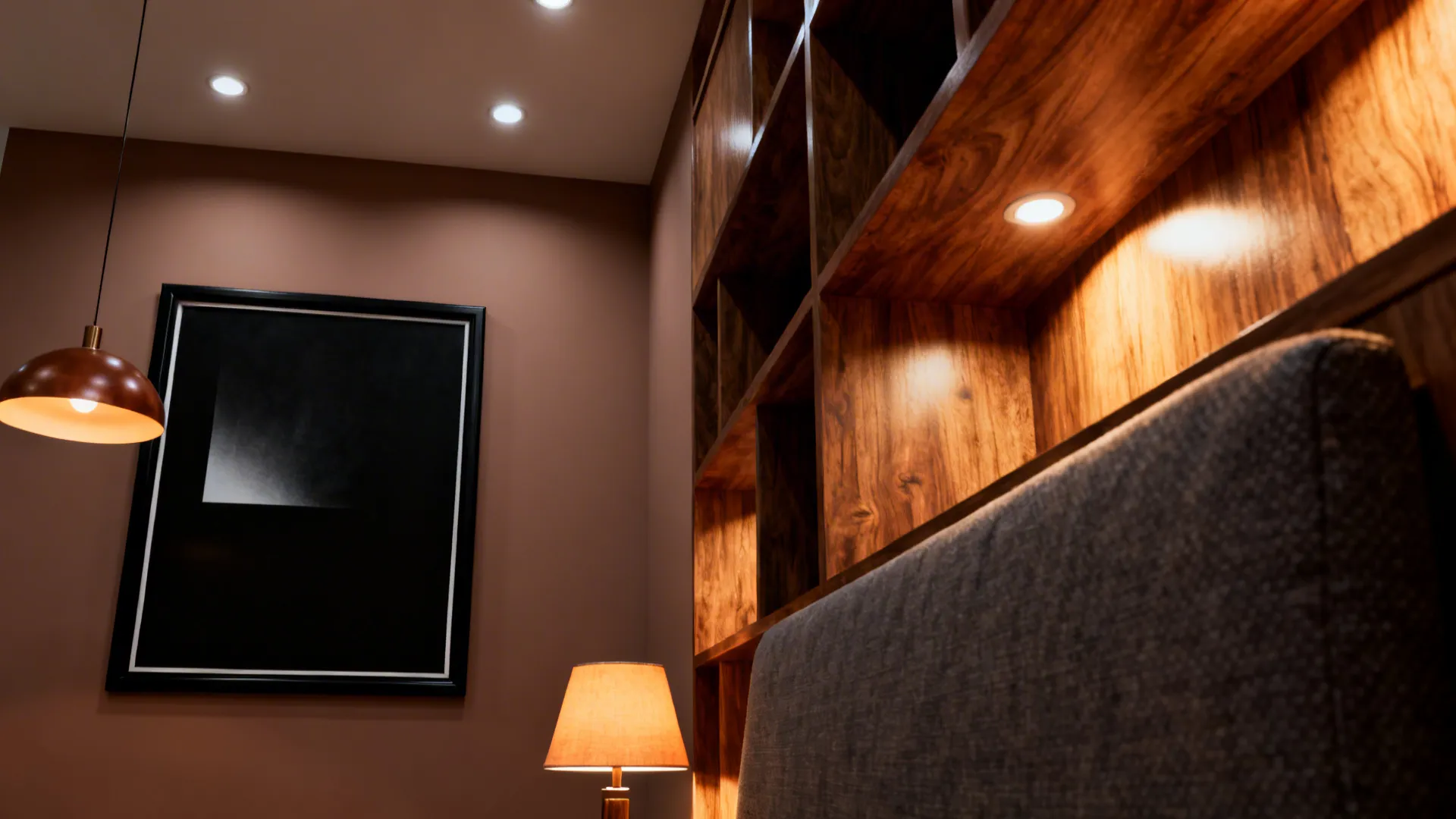Black-framed art on a taupe wall with layered warm lighting highlighting wood grain and fabrics.