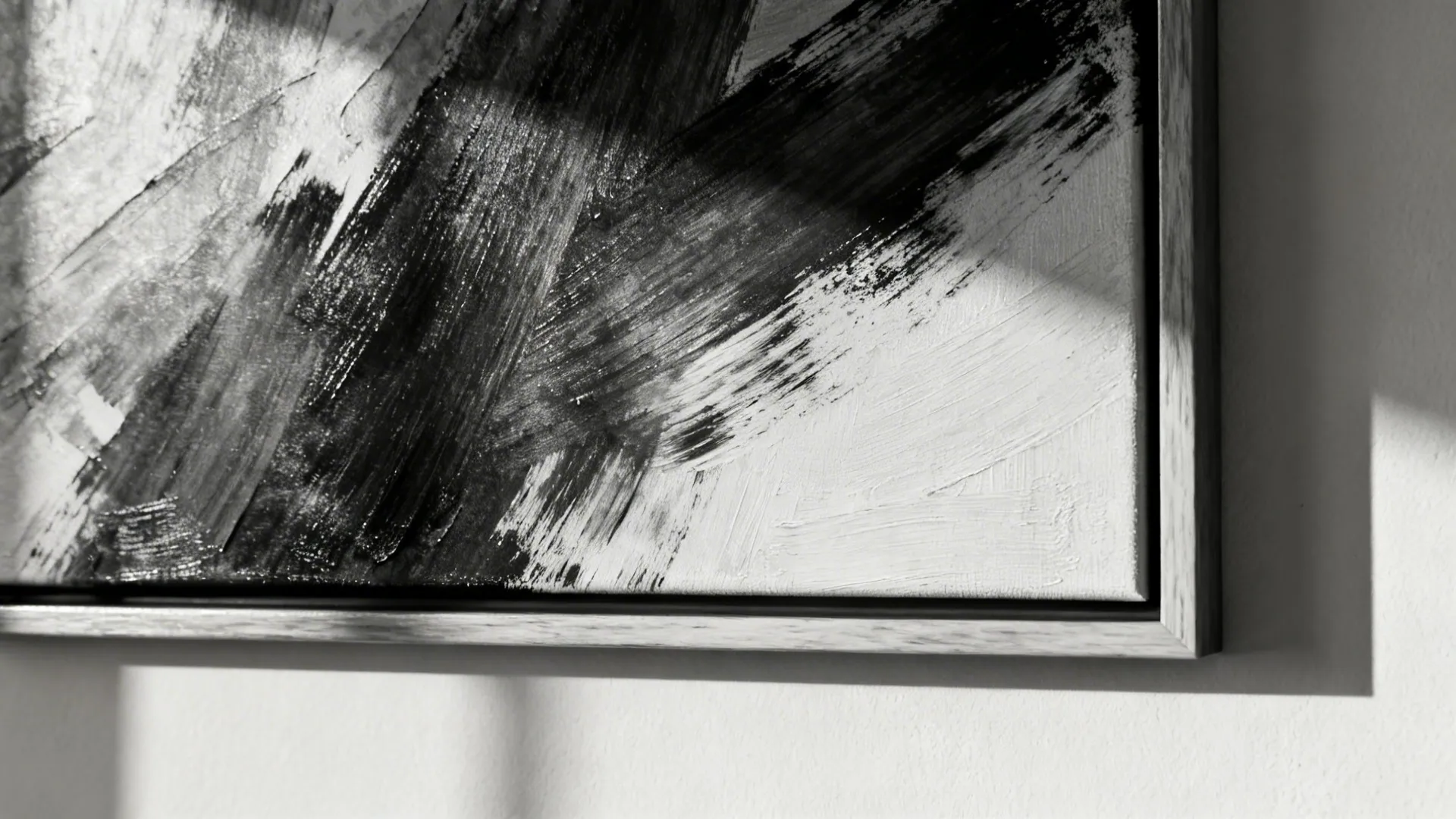 Macro view of a black-and-white abstract artwork with gallery frame and brush texture.