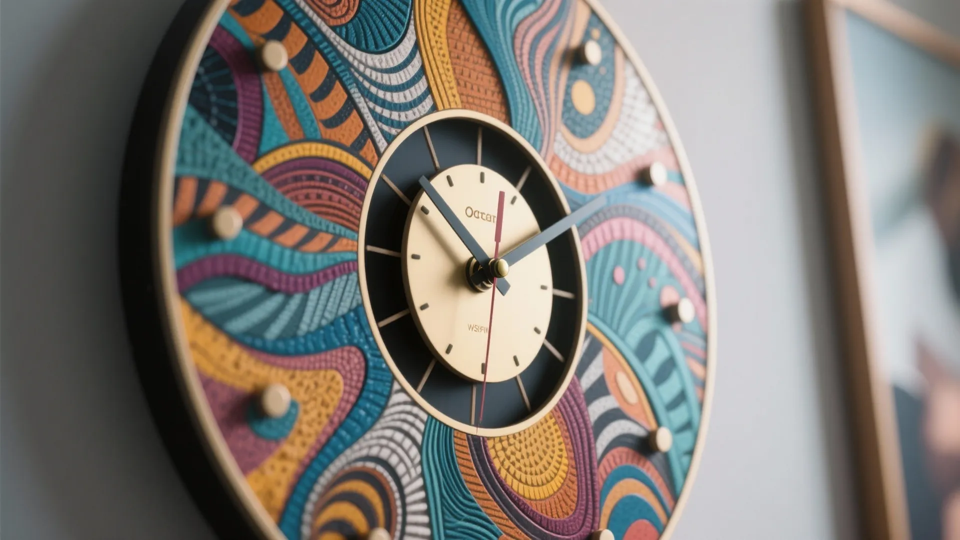 Modern round wall clock with colorful artistic patterns and gold clock face in a bright room