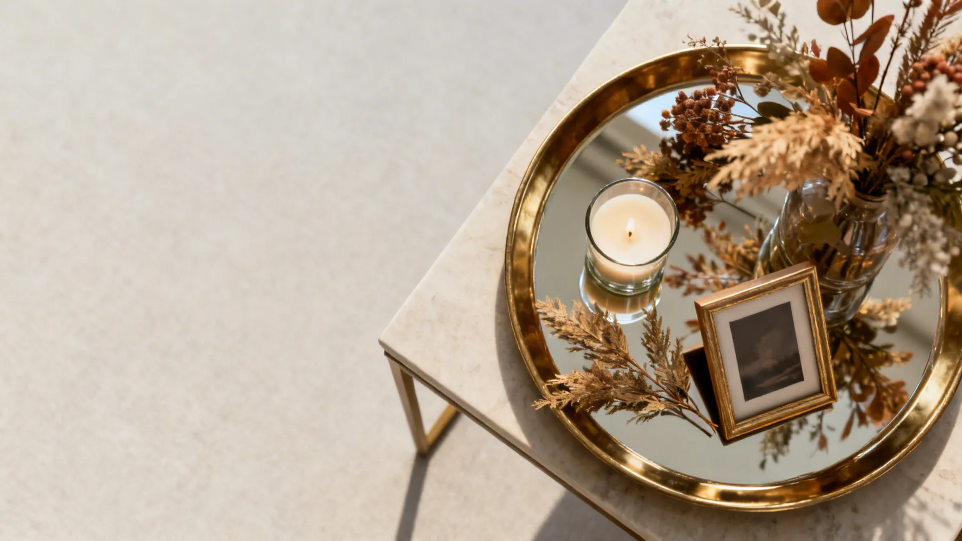 Top-down view of a decorative tray with seasonal items on a side table.