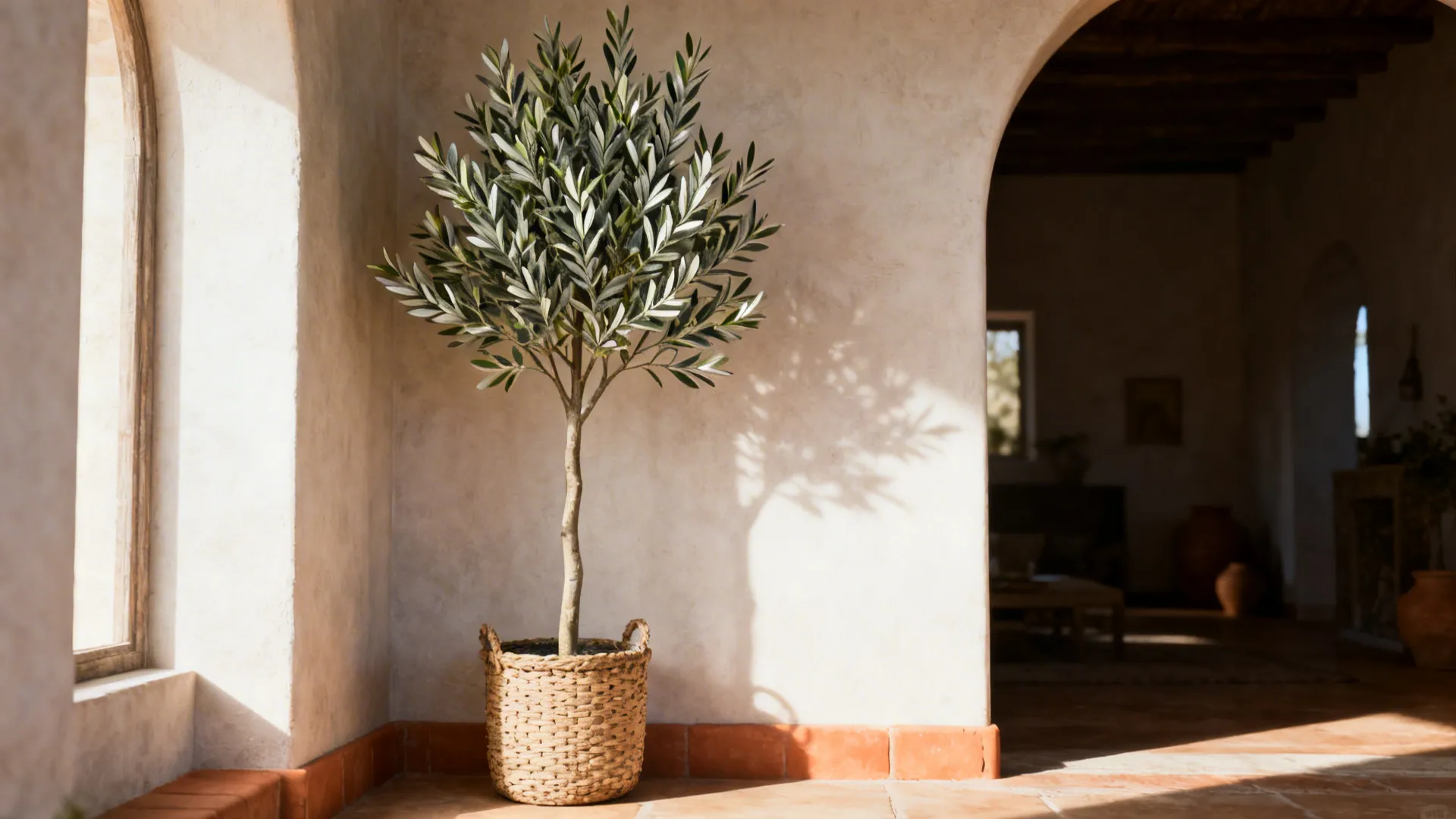 Tall artificial olive tree in a woven basket adding Mediterranean character to a corner