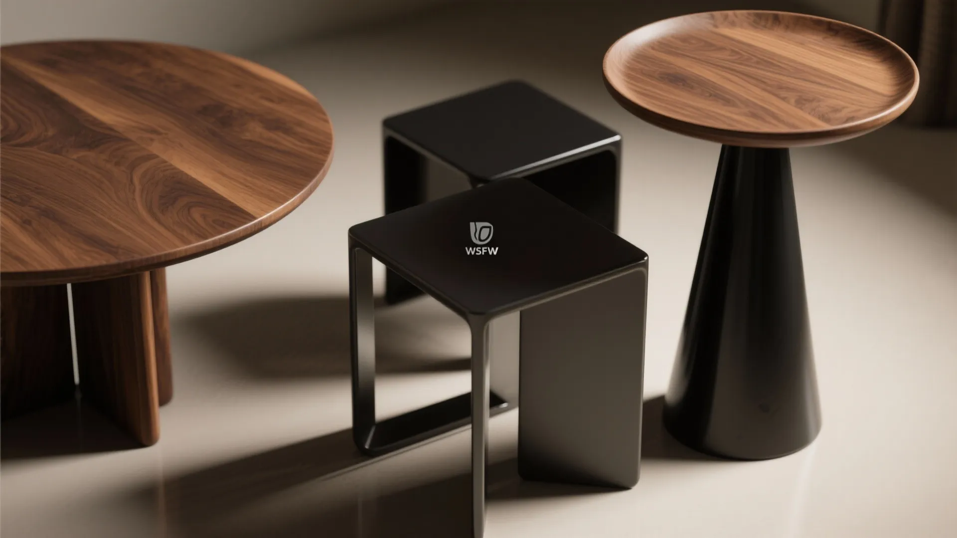 Close-up of three asymmetric accent tables showing different shapes and finishes.