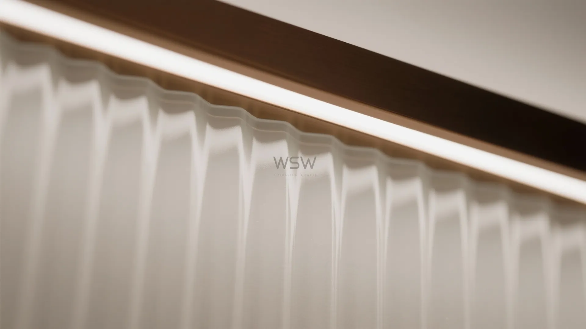 Close-up of wavy textured glass panel with warm light strip along the top dark edge