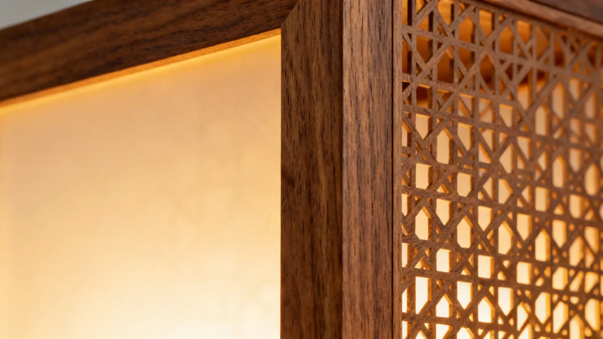 Macro of backlit teak veneer and laser-cut lattice joint glowing warmly.