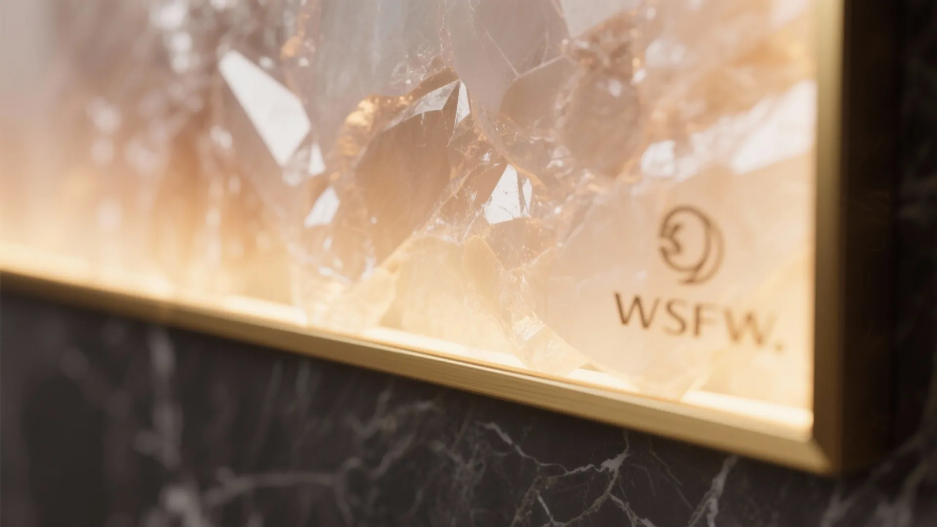 Macro of a backlit onyx panel with warm crystalline glow and brass edge trim.