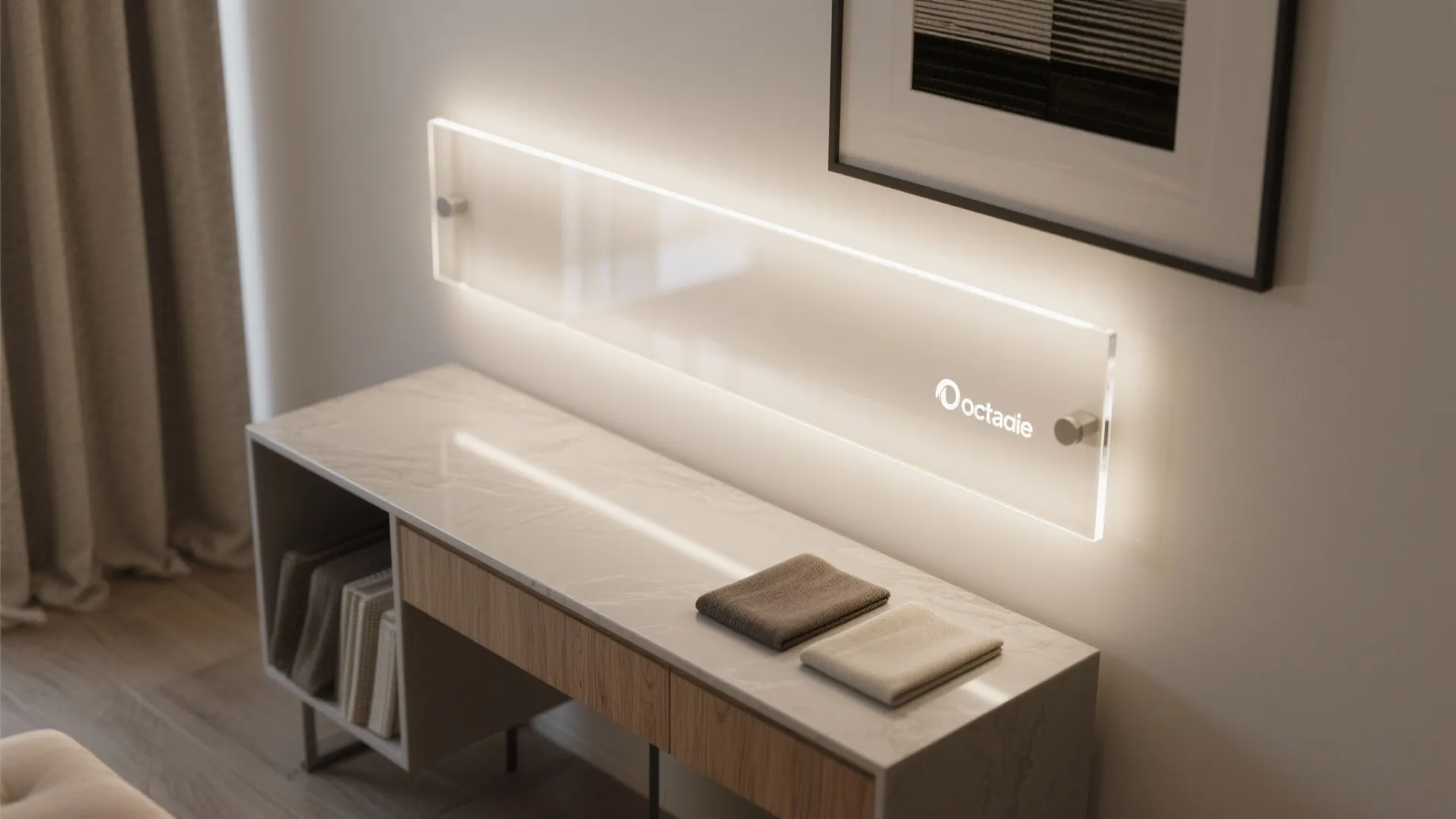 Glowing wall light panel mounted above a marble table with books and a framed picture