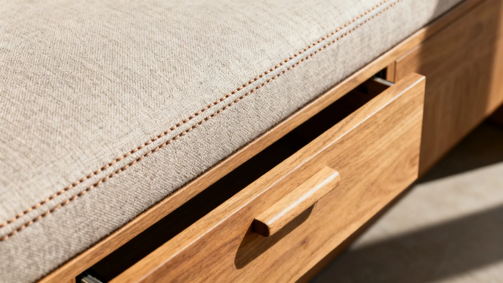 Close-up of a banquette drawer and stitched performance fabric cushion.
