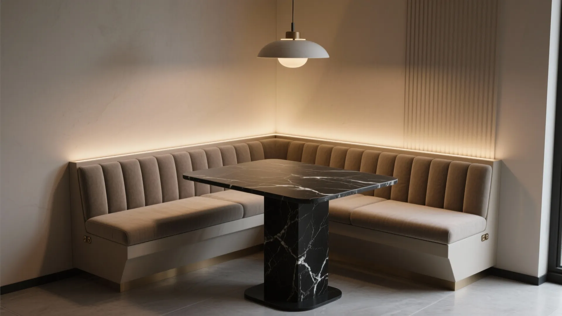 Small dining corner featuring black marble table beige sofa seating wall panel and ceiling light