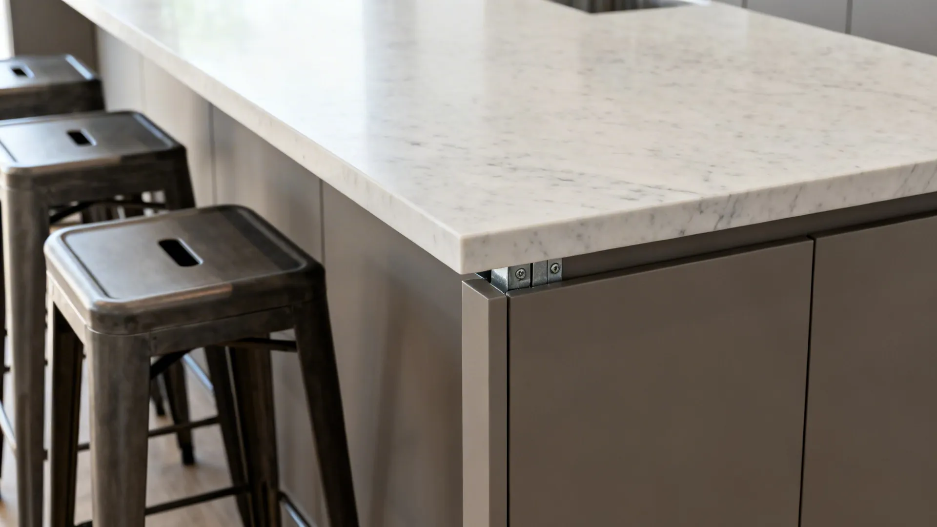 Macro of a 42-inch bar-height stone overhang with hidden bracket and matte cabinet junction.