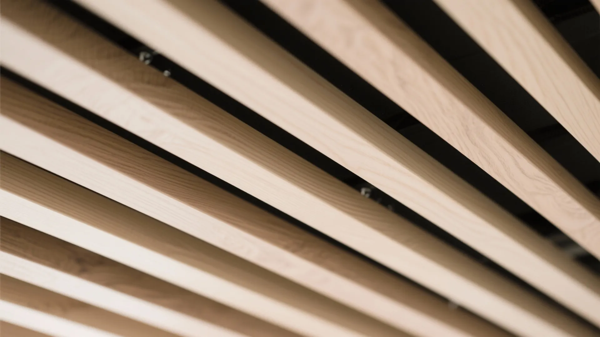 Close-up of light brown wood slats on a ceiling creating a modern linear texture design