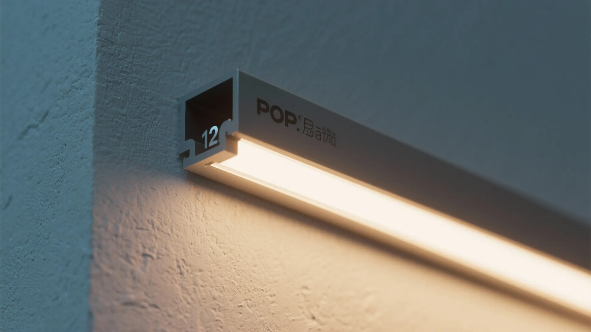 Close up of a modern linear light fixture installed on a textured grey wall surface