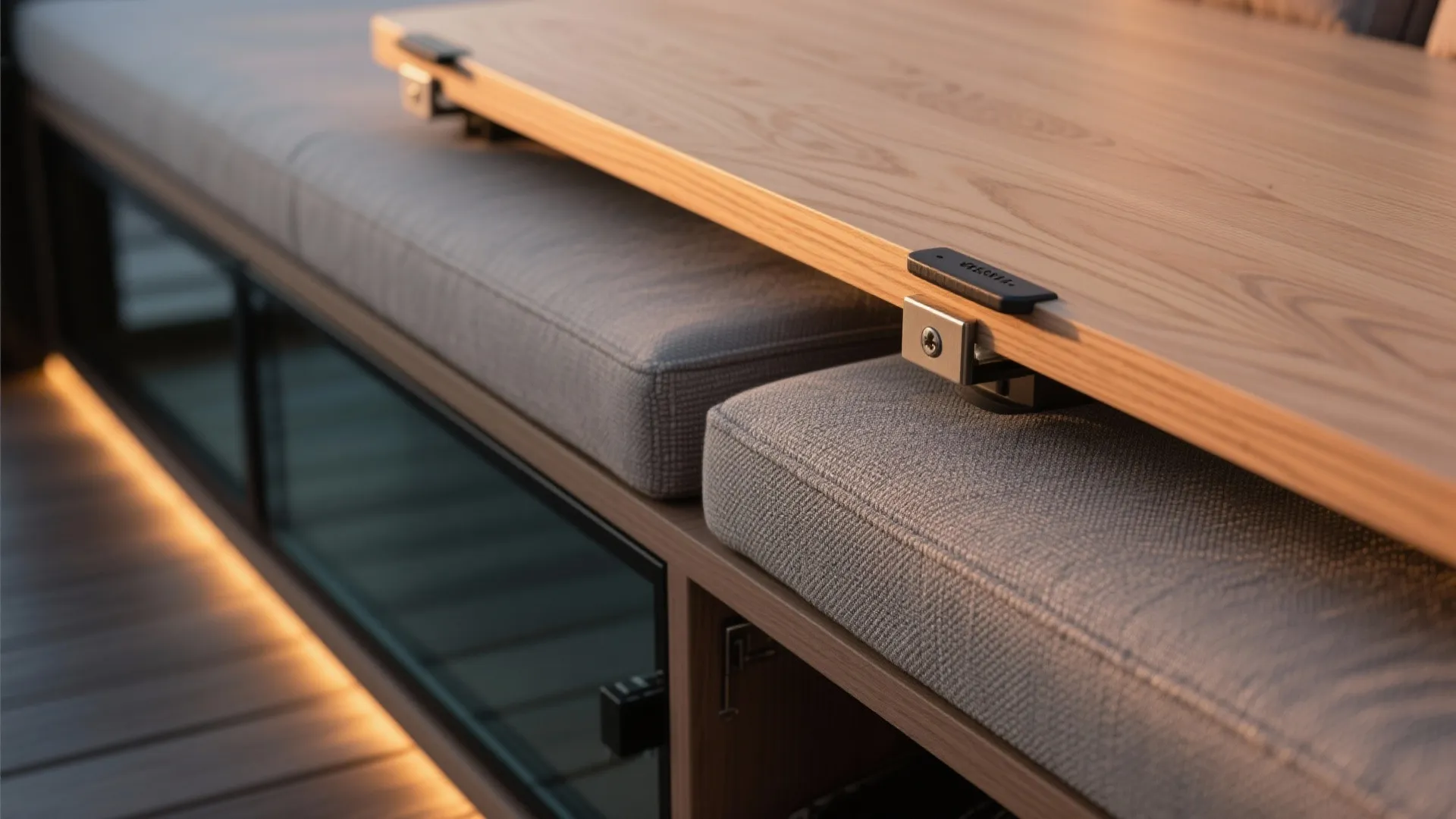 Macro of storage bench lid with concealed hinge and gasket next to the base of a laminated glass wind screen.