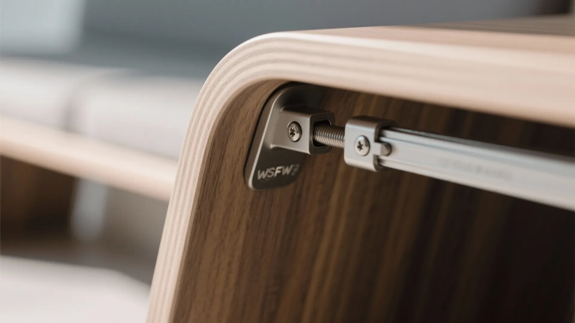 Close up view of metal hardware connecting wooden furniture parts in a modern interior design