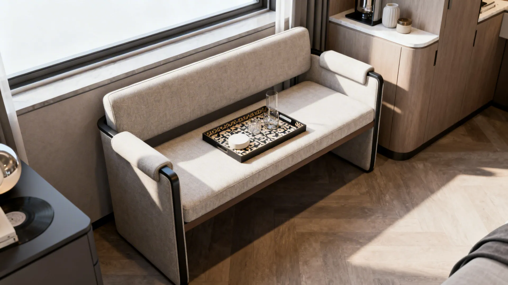 Bench-style chair with low arms used as seating and occasional table in a small living room