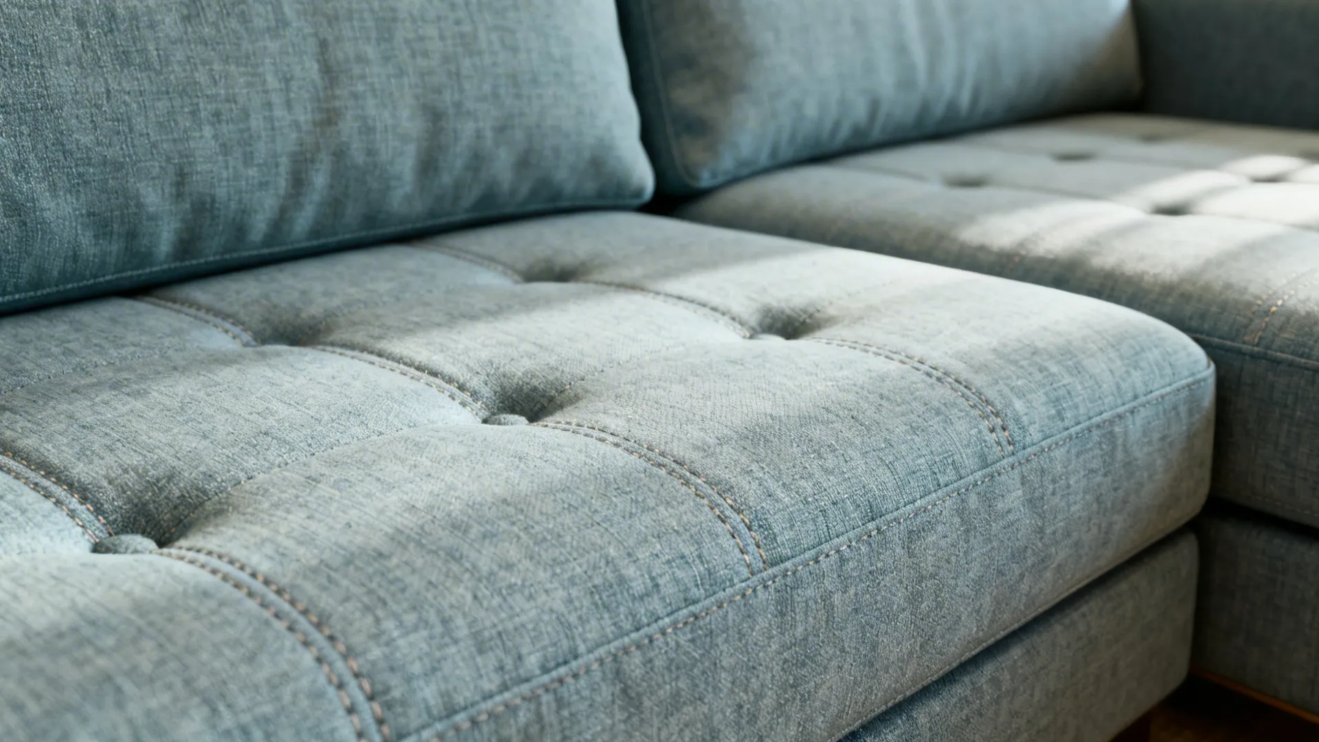 Bench-style cushions and low tufted seats on sofa and loveseat creating a continuous seating look.