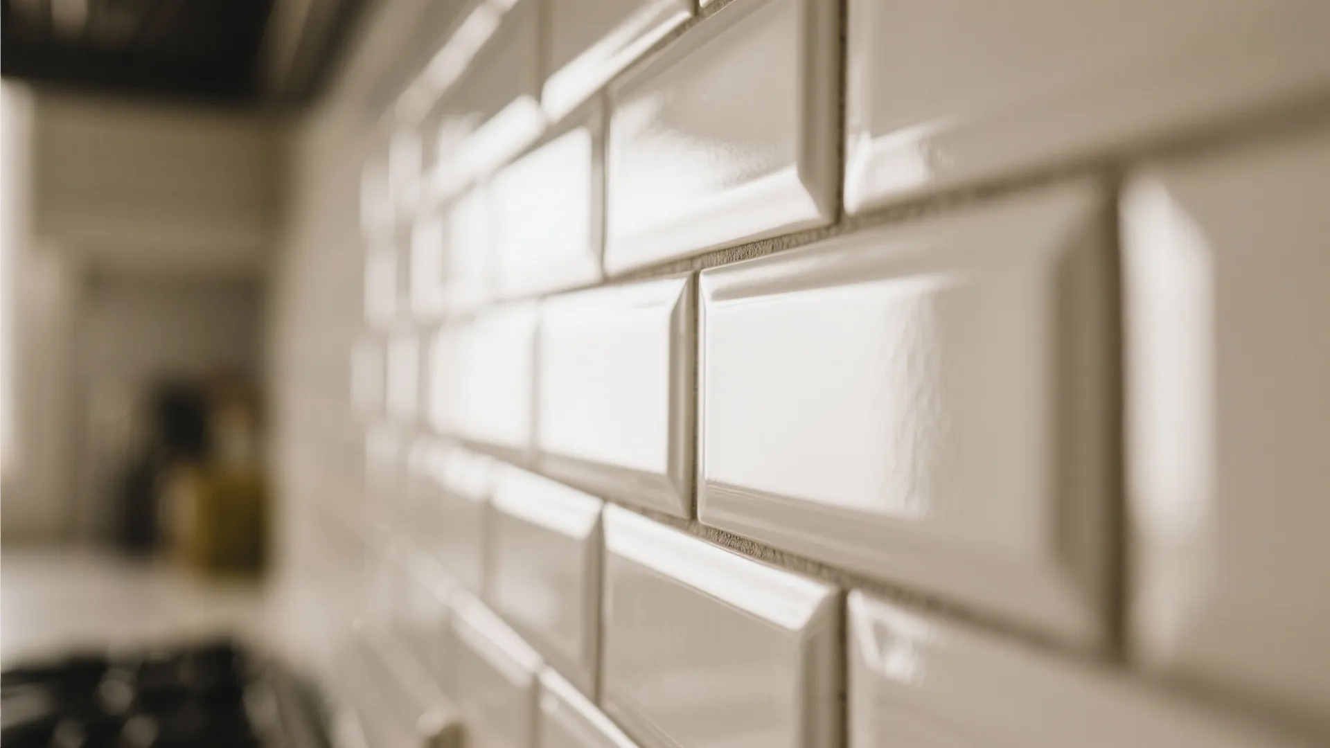 Close up view of white glossy wall tiles with angled edges in a bright kitchen