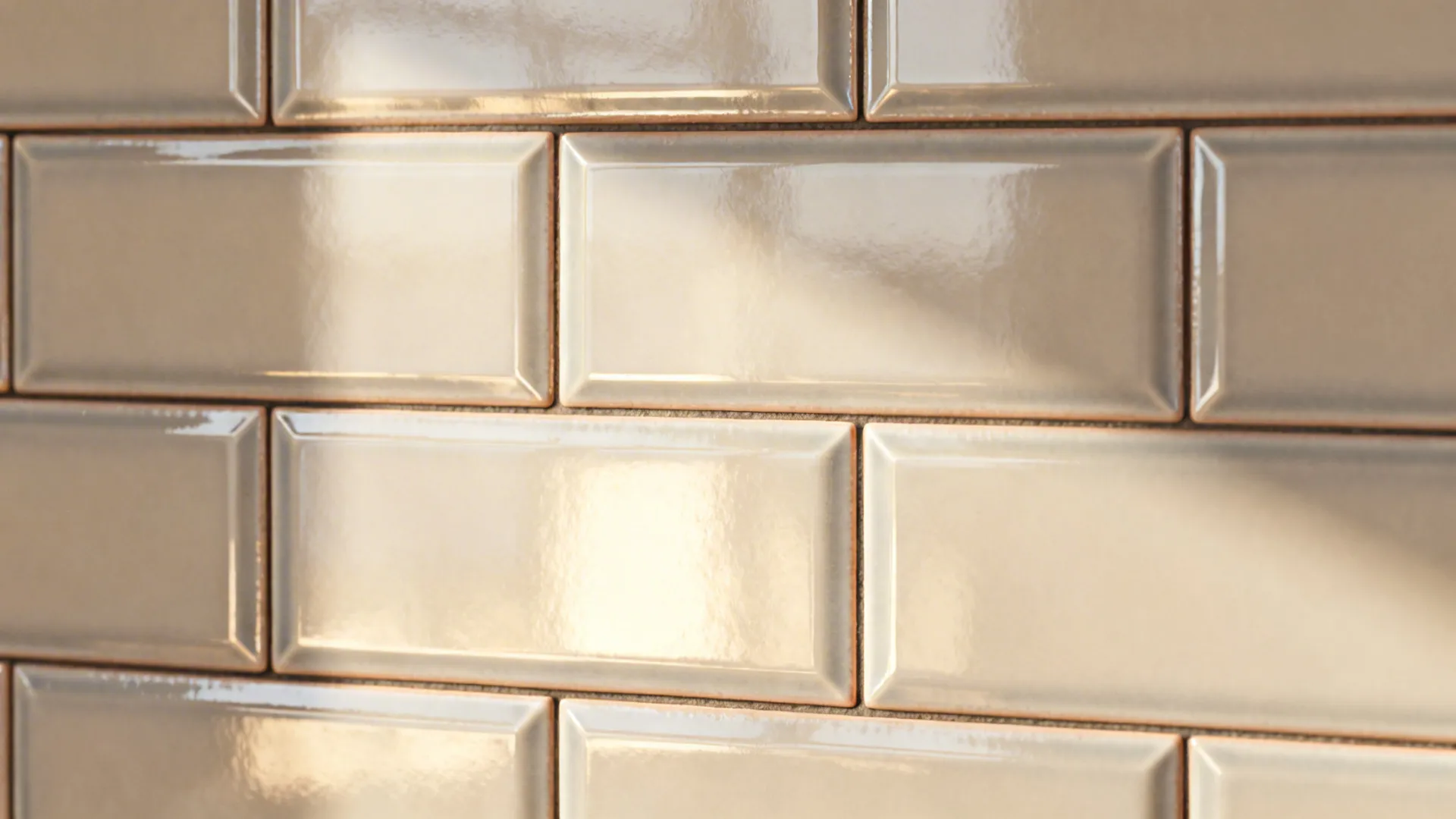 Glossy beveled subway tiles reflecting light and showing textured glaze