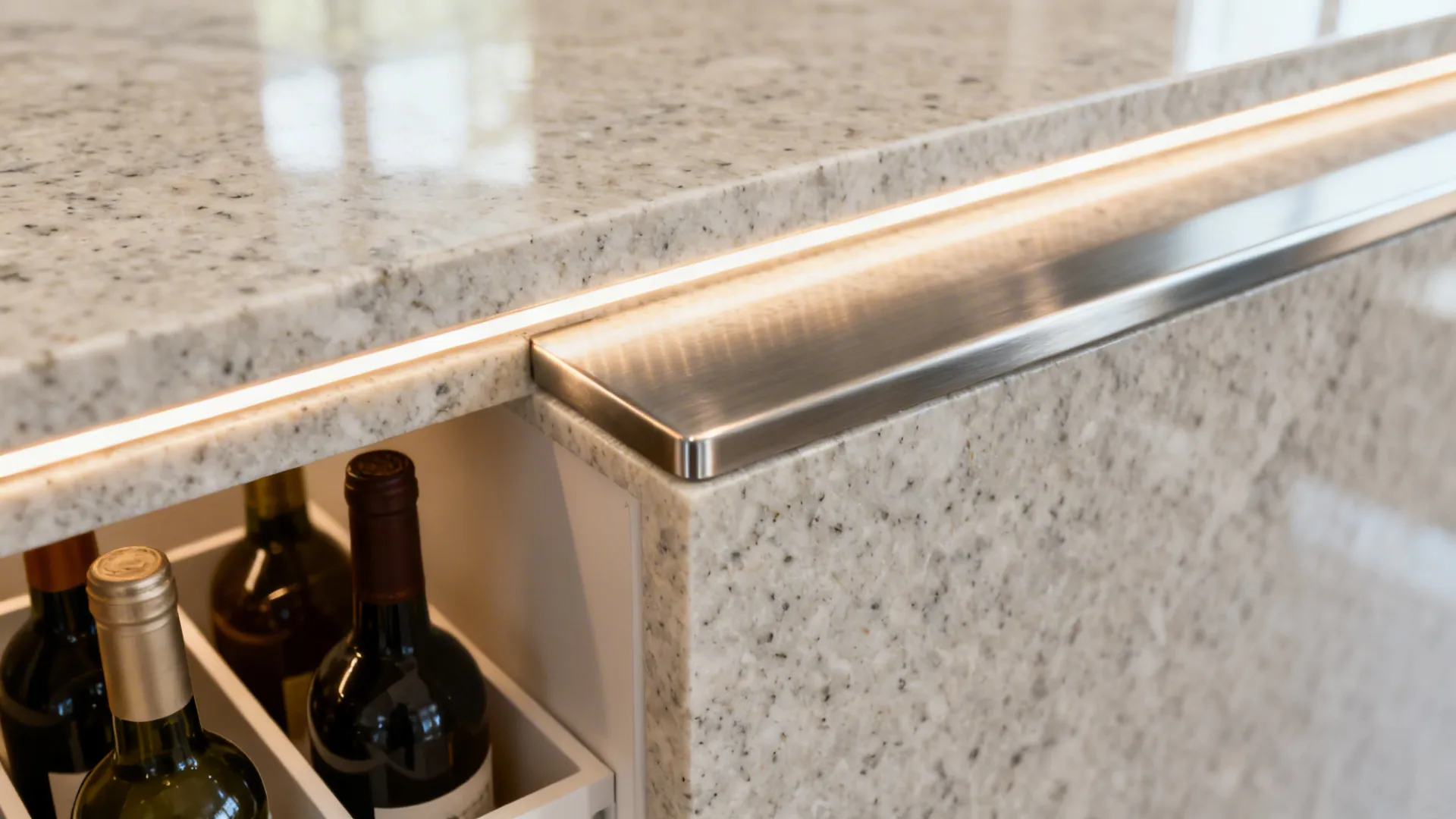Close-up of a quartz waterfall niche with LED lighting and bottle dividers.