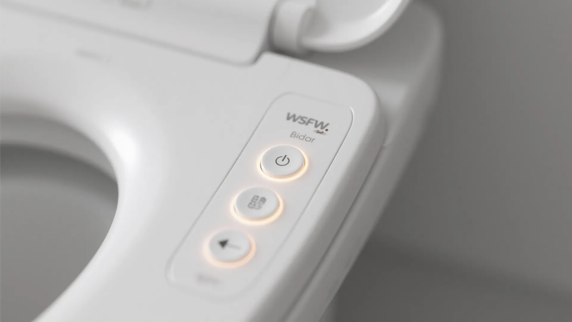Close-up of a heated bidet seat’s backlit control interface on a smooth white surface.