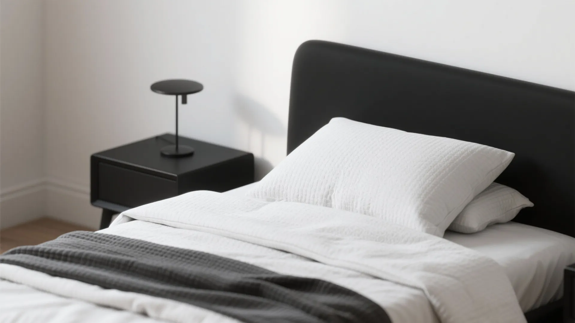 1. Monochrome Minimalism with a Bold Bedframe