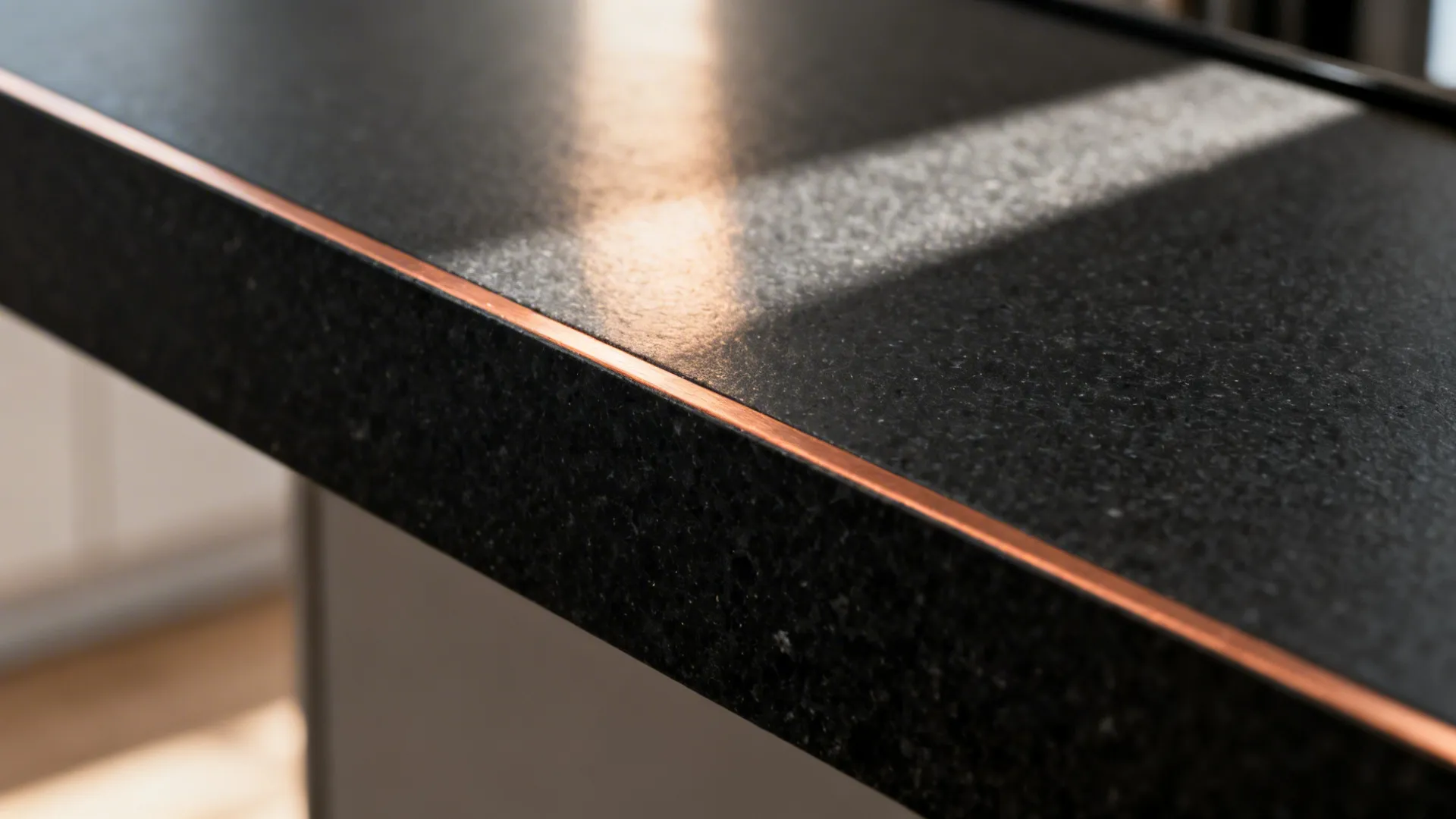 Honed black quartz countertop featuring a thin brushed copper inlay at the edge.