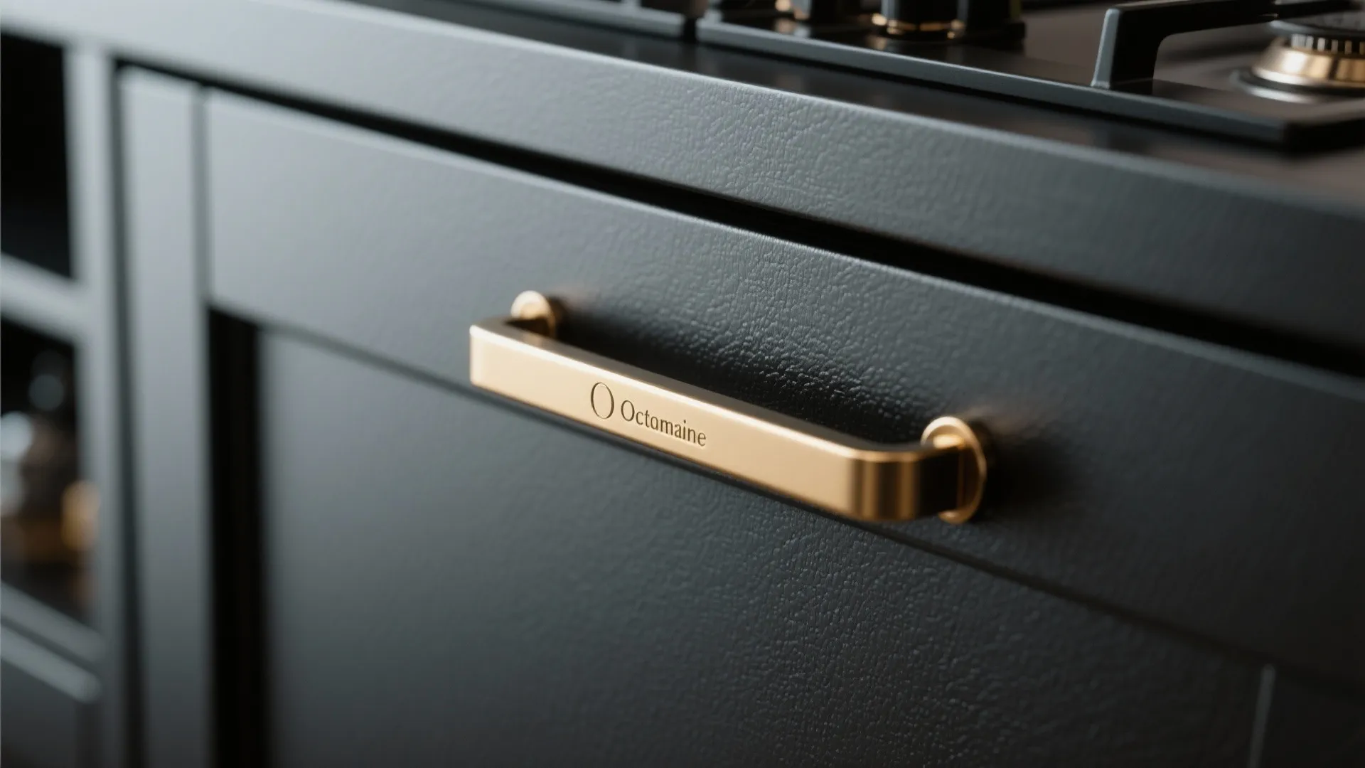 Close-up of brass handle on black kitchen cabinet